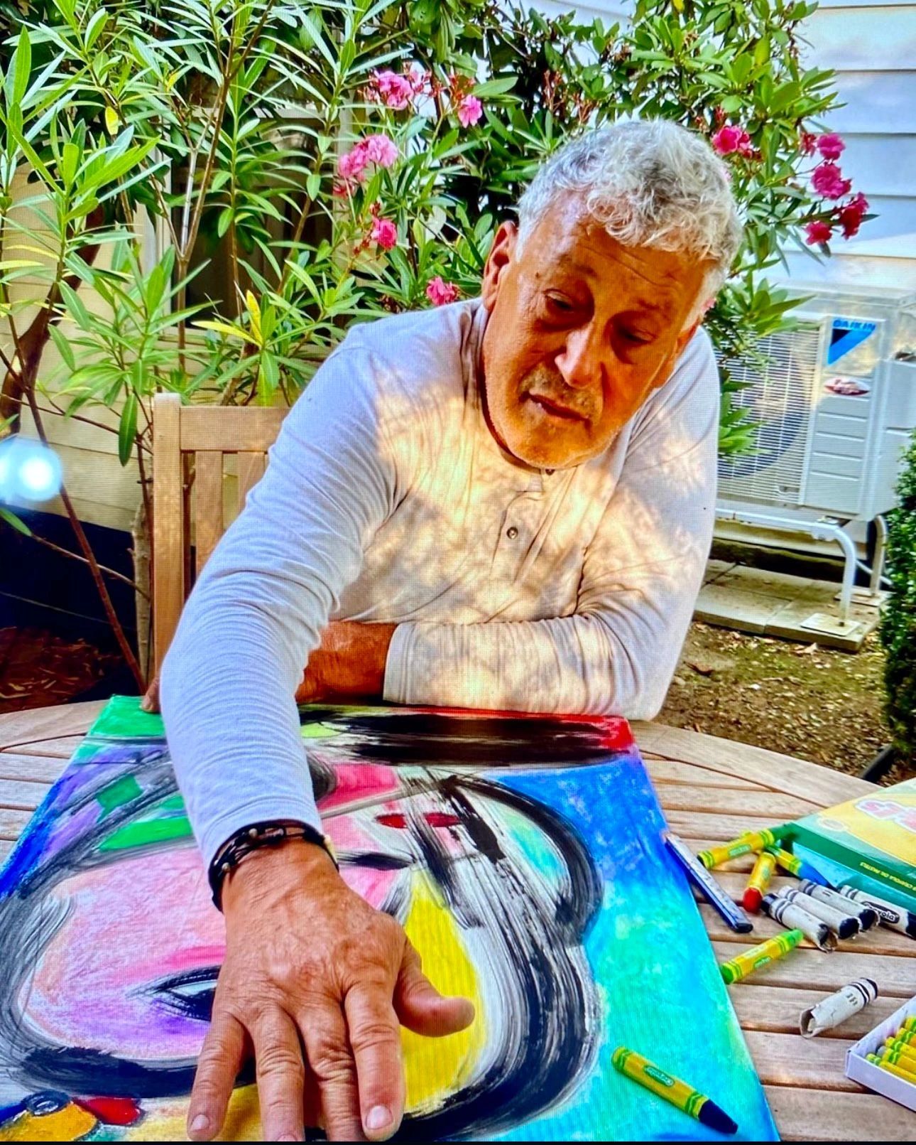 Close-up of Agustin Ochoa's hand over a colorful painting